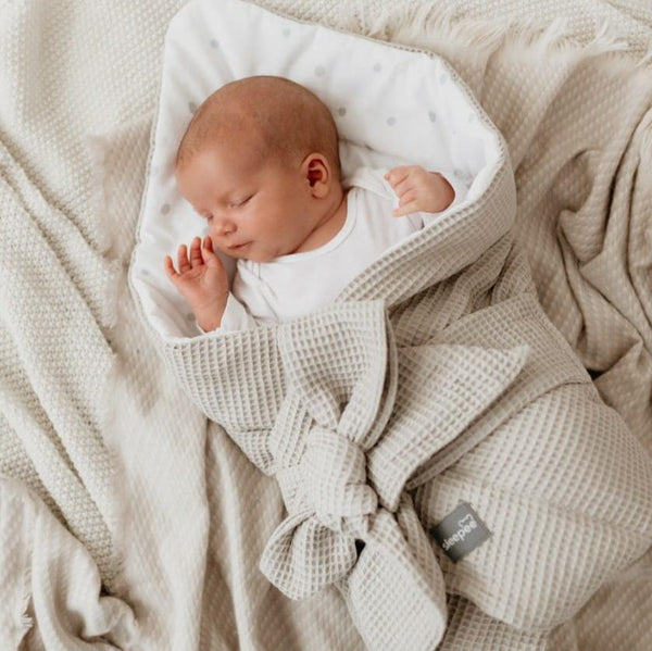 Sleepee Waffle Swaddle Blanket with adjustable bow tie and anti-allergic filling, providing comfort and security for newborns.