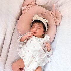 Sleepee Velvet Teddy Bear Pillow with indent for flat head prevention, matching velvet swaddle blankets for a stylish newborn set.