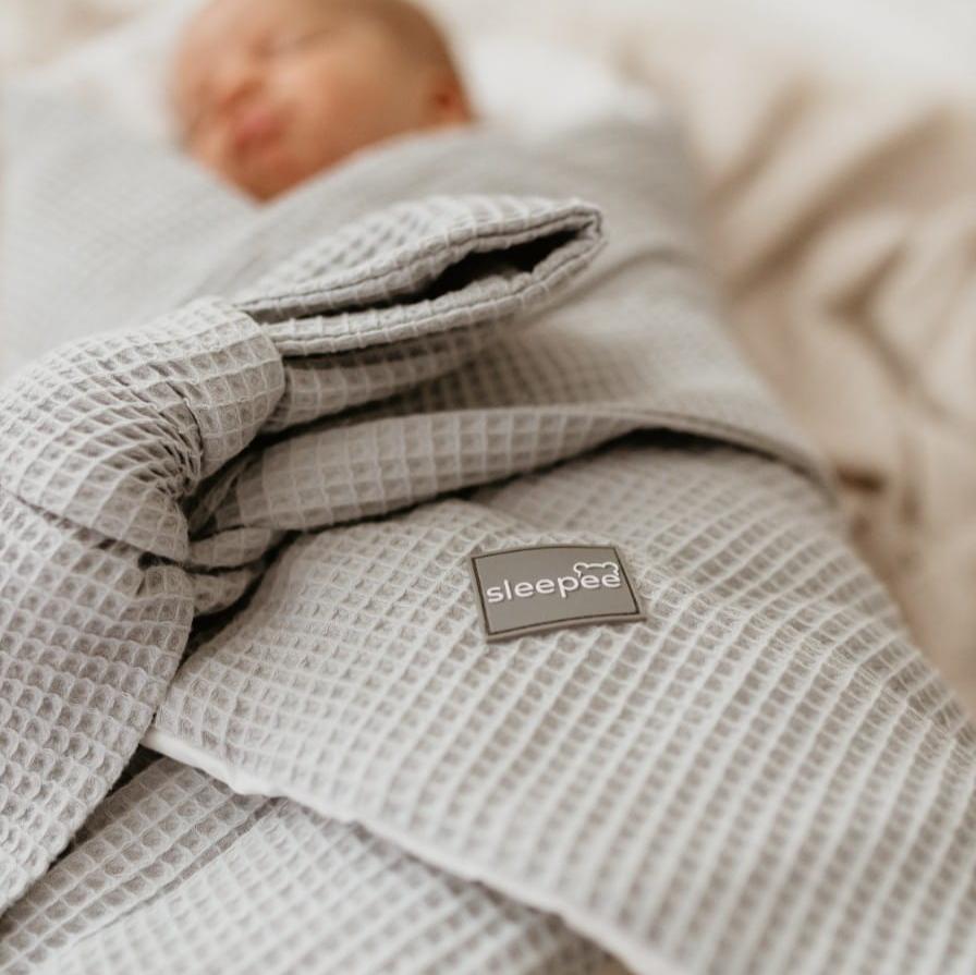 Sleepee Waffle Swaddle Blanket with adjustable bow tie and anti-allergic filling, providing comfort and security for newborns.