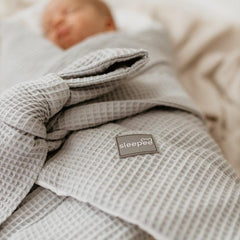 Sleepee Waffle Swaddle Blanket with adjustable bow tie and anti-allergic filling, providing comfort and security for newborns.
