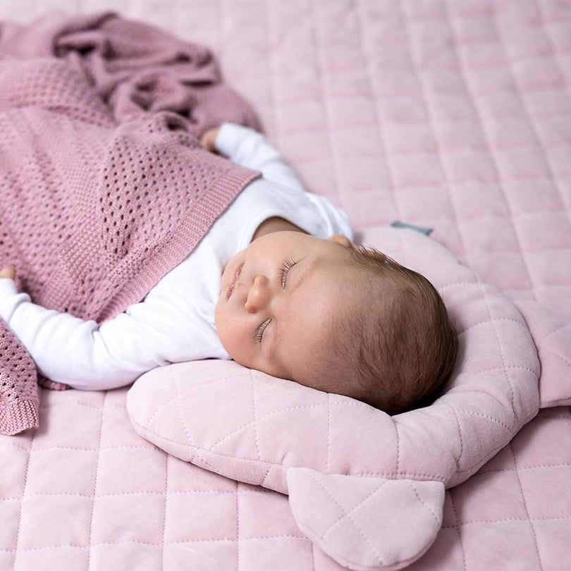 Sleepee Velvet Teddy Bear Pillow with indent for flat head prevention, matching velvet swaddle blankets for a stylish newborn set.